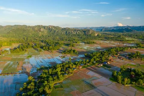 Patchwork flooded fields and limestone hills at sunrise 스톡 사진
