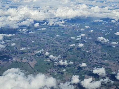 Patchwork of Green Fields Beneath Scattered Cumulus Clouds Stock Photos