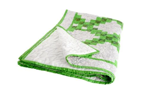 Patchwork green-white quilt on a white background. Patchwork blanket. Handmad Foto stock