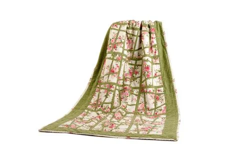 Patchwork green-white quilt on a white background. Patchwork blanket. Handmad Stock Photos