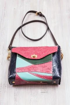 Patchwork leather evening bag on gray table 写真素材