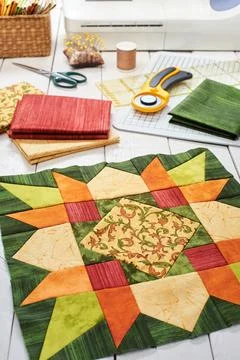 Patchwork orange-green block, quilting fabrics, sewing accessories Stock-Fotos