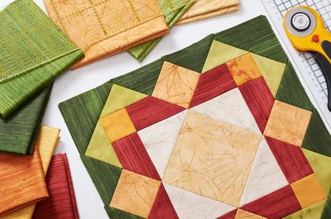 Patchwork orange-green block, quilting fabrics, sewing accessories Stock-Fotos