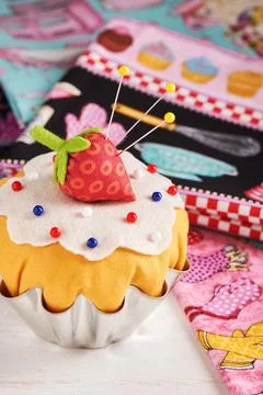 The patchwork pin cushion like a cupcake with strawberry Fotos de archivo