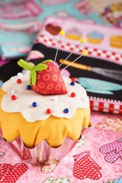 The patchwork pin cushion like a cupcake with strawberry Fotos Stock