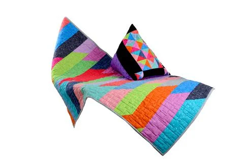 Patchwork quilt and pillow on a white background. Patchwork blanket. Handmade Stock Photos