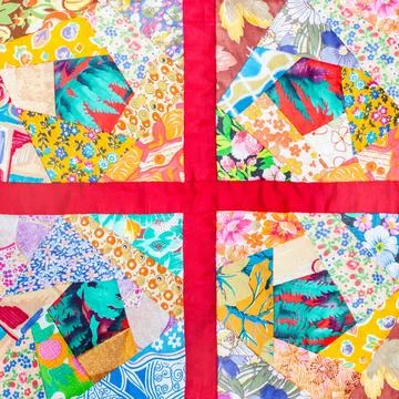 Patchwork quilt framed in red cloth four details of hand made patchwork qu... Stock-Fotos