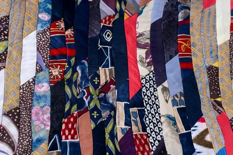 Patchwork Quilt Made of Repurposed Neckties. A fragment of multi-colored pieces Stock Photos