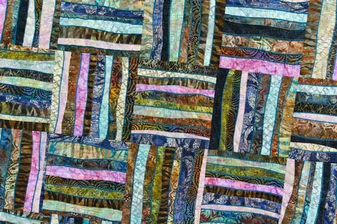 A patchwork quilt with many different colored squares Stock Photos