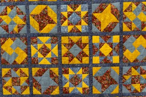 A patchwork quilt with many geometric shapes Stock Photos