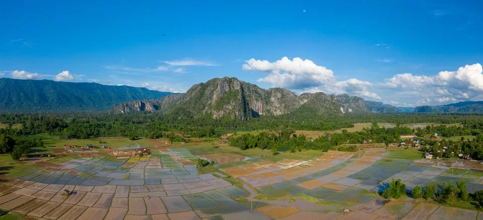 Patchwork rice paddies and limestone mountains in Laos Stock Photos