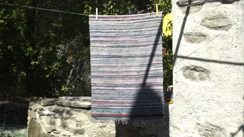 Patchwork rug hanging to dry 스톡 동영상 144669067