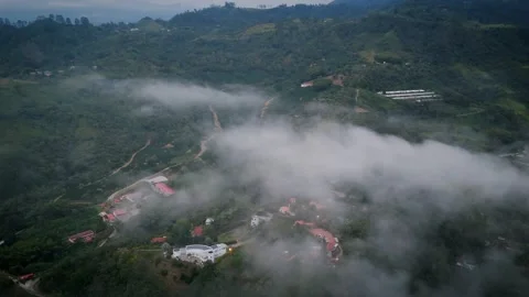 Patchwork Settlement Peeking Through Layered Vapor Banks Stock Footage 316864439