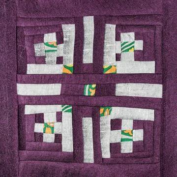 Patchwork with silver pattern of purple fabrics Stock Photos