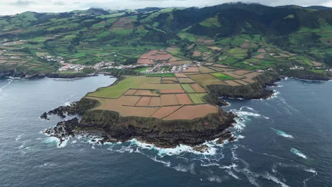 Patchwork terraced fields covering volcanic headland Stockbeeldmateriaal 330483858