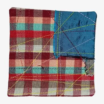 Patchwork textile sample with stitched fabric fragments 库存照片