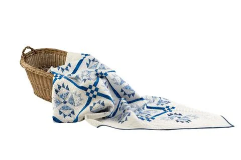 Patchwork white-blue quilt on a white background. Patchwork blanket. Handmade Stock Photos