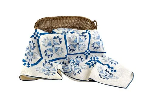 Patchwork white-blue quilt on a white background. Patchwork blanket. Handmade Stock Photos