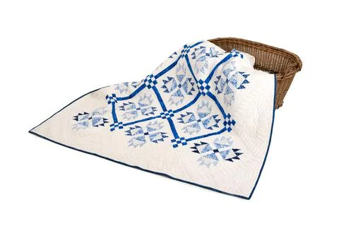 Patchwork white-blue quilt on a white background. Patchwork blanket. Handmade Foto stock