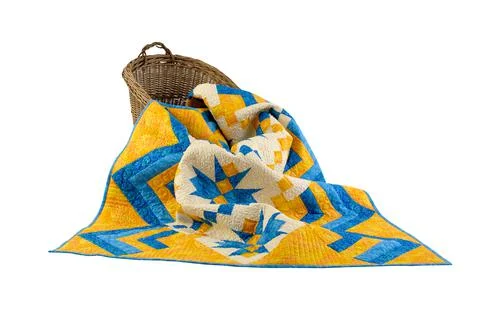 Patchwork yellow-blue quilt on a white background. Patchwork blanket. Handmad Stock Photos