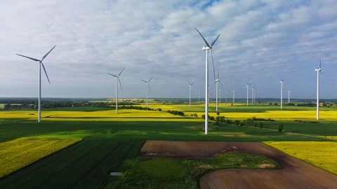 Patchwork of yellow, green, and brown fields with slowly spinning wind Stock-Footage 245252578