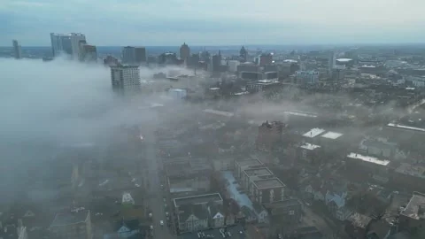 Patchy White Clouds Enveloping The Lakefront City Streets And Buildings Of Stock Footage 340044503