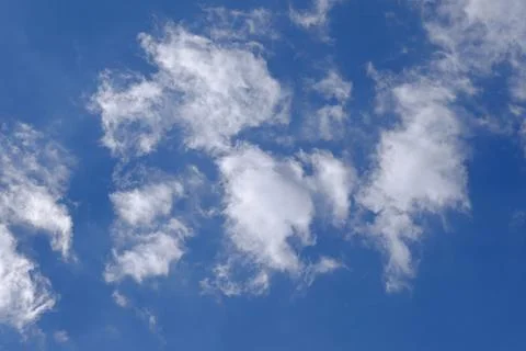 Patchy White Cumulus Clouds Against a Bright Blue Sky Stock Photos