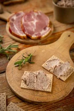 Pate or meat spread is placed on crackers Stock Photos