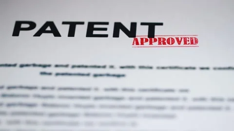 Patent document is approved by a hand with a stamp, signifying successful i.. Stock Footage 334854936
