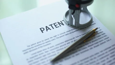 Patent document approved, hand stamping seal on official paper, copyright law Stock Footage 97281405