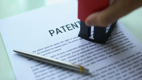 Patent document rejected, hand stamping seal on official paper, copyright law Stock Footage 97281560