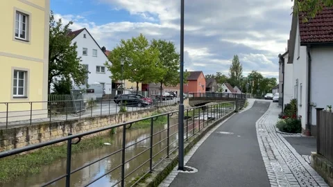 Path along the Krumbach stream in Zeil am Main, Germany Stock Footage 221356707
