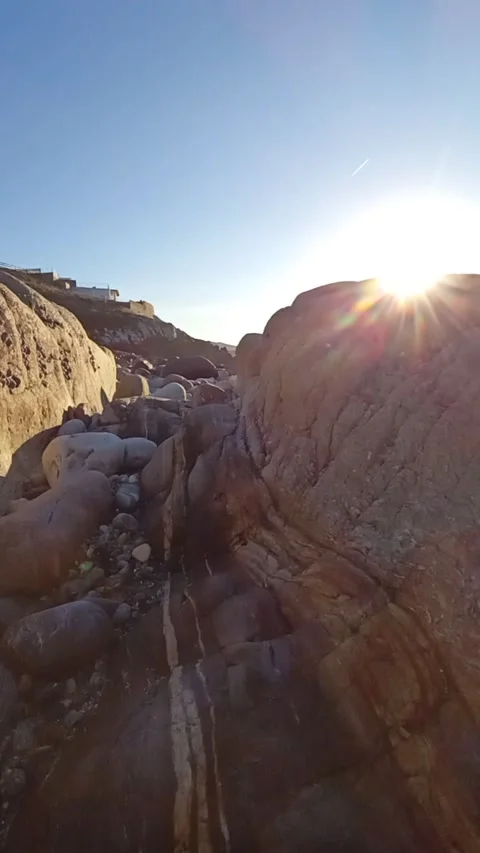 Path along the rocky ocean floor at low tide during sunset Stock Footage 236644212