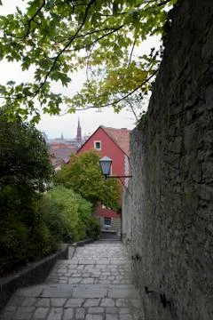 Path along stone wall with views of city Stock Photos