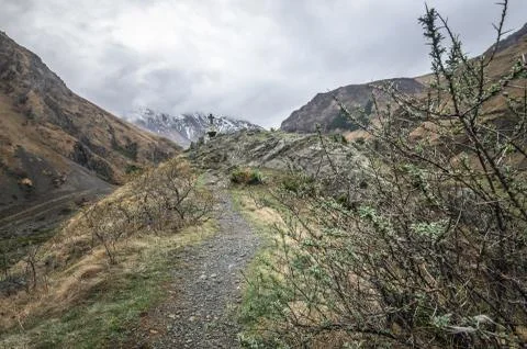 Path to ancient medieval monument in mountains of Caucasus. Christian cross i Stock Photos