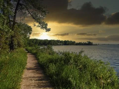 Path between forest and lake in canada Stock Photos