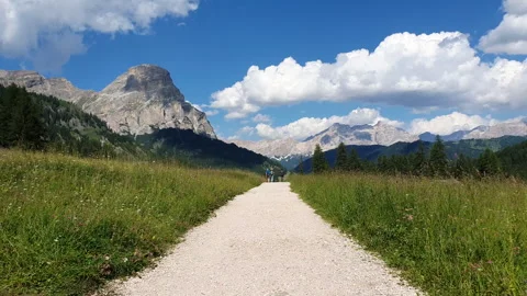 Path between green meadows and the Dolomites Stock Footage 270423807