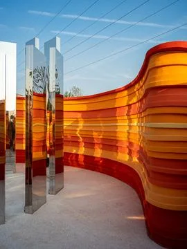 Path between mirrored pillars and orange walls - Contrast concept Stock Photos