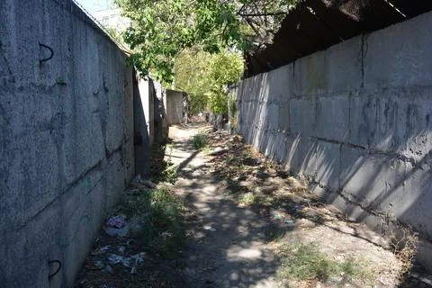 Path between new fence made of slabs and second old carp fence. Foto stock