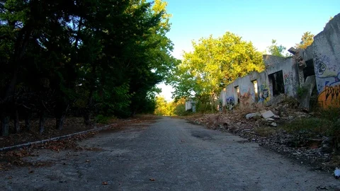 PATH BETWEEN TREES AND RUINED BUILDING Stock Footage 94449607