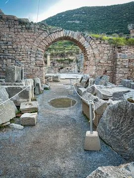Path Carves Through Rubble Archway in Pergamon Temple Ruins Over Hillside Stock Photos