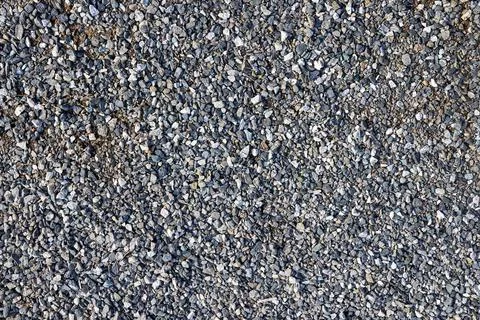 A path covered with small stones. Texture, background. Stock Photos
