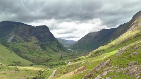 Path that crosses the enormous mountains of the Highlands, in Scotland. Stock Footage 311575149
