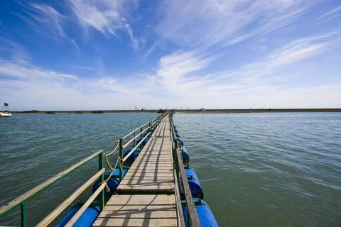 Path Forward Over Water Under Open Blue Sky Stock Photos