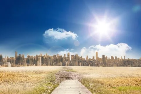 Path on grass with cityscape on horizon Ilustración de archivo