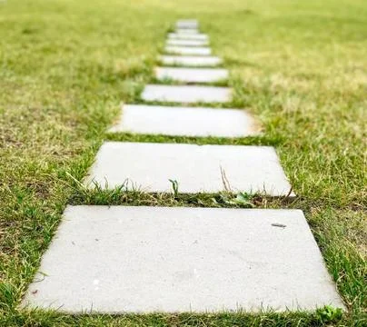 Path of gray plates on green grass Stock Photos