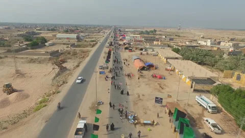 The path to Karbala al-Hussein. Iraq, pilgrims go to Karbala (aerial view) Video stock 106924263