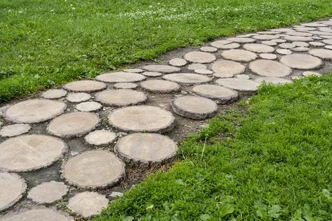 The path is laid out of round sections of wood Stock Photos