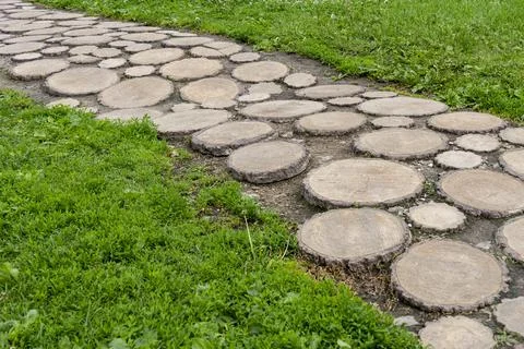 The path is laid out of round sections of wood Stock Photos
