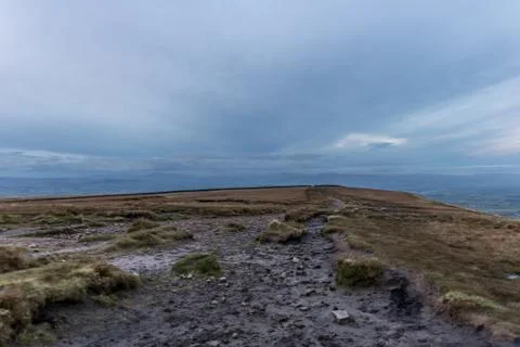 Path with landscape leading on hill, clouds and colored sky Stock-Fotos